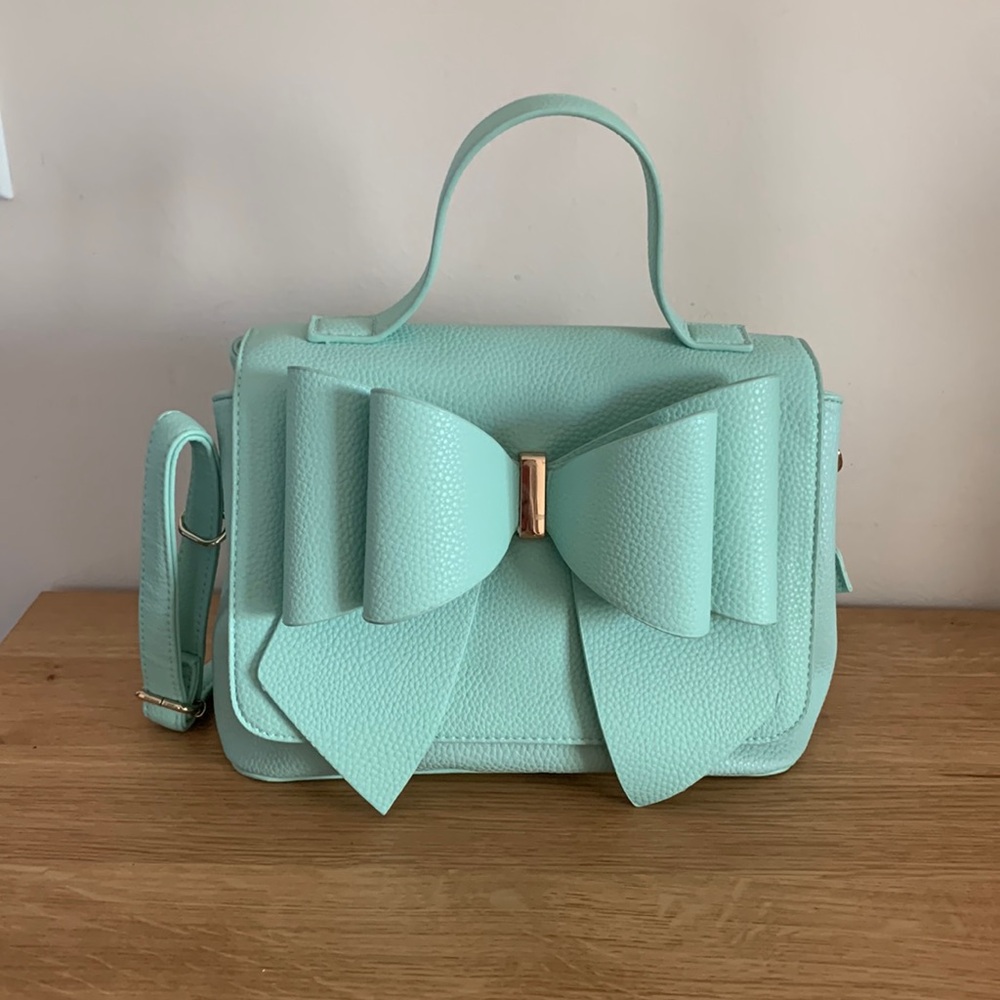 Crossi turquoise cross body bag with a bow